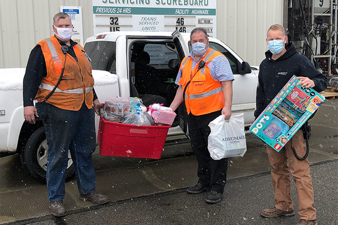 Darius LaPierre, right, and coworkers load donations.