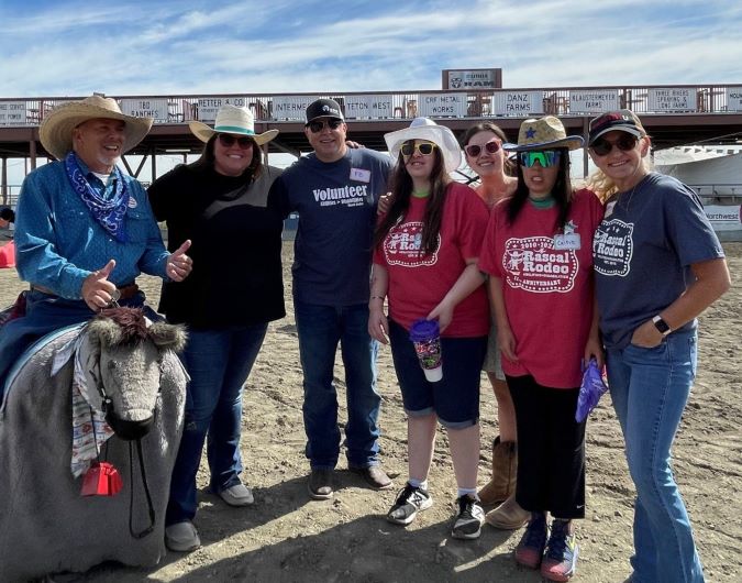 McCord, center, with family members and rodeo volunteers at an event