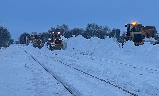 Front-end loaders are among the types of equipment used to clear tracks.